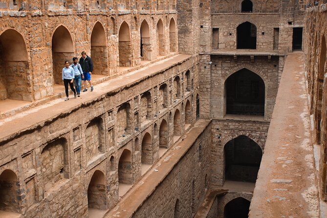 Delhi Full Day Sightseeing by Car - Qutub Minar: a tall monument with a complicated setting