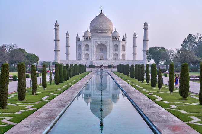 The Taj Mahal at first light, mirrored in the long water channel at Agra